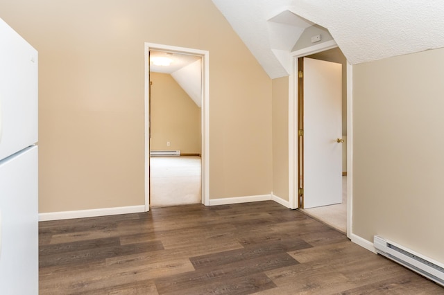 bonus room featuring a baseboard heating unit, lofted ceiling, and wood finished floors
