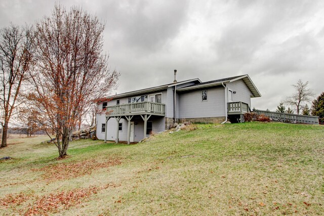 6775 State 87 SW, Backus, MN 56435 - rear view of property with a lawn and a wooden deck