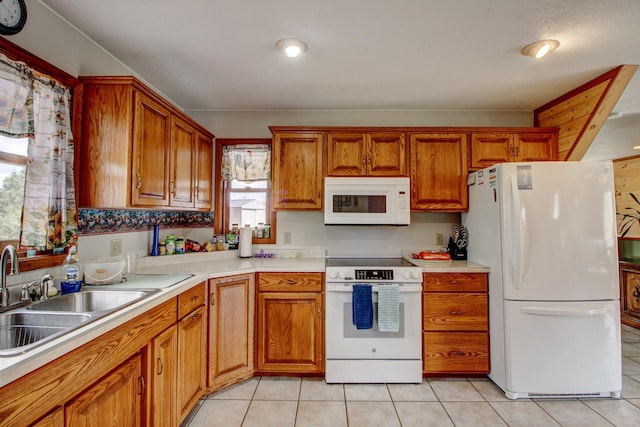 6775 State 87 SW, Backus, MN 56435 - kitchen featuring a sink, brown cabinets, white appliances, and a healthy amount of sunlight