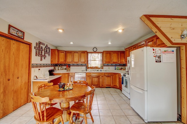 6775 State 87 SW, Backus, MN 56435 - kitchen with brown cabinets, light tile patterned flooring, a sink, white appliances, and light countertops