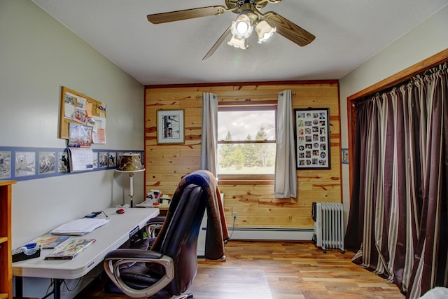 6775 State 87 SW, Backus, MN 56435 - office area with wooden walls, ceiling fan, radiator heating unit, wood finished floors, and a baseboard radiator