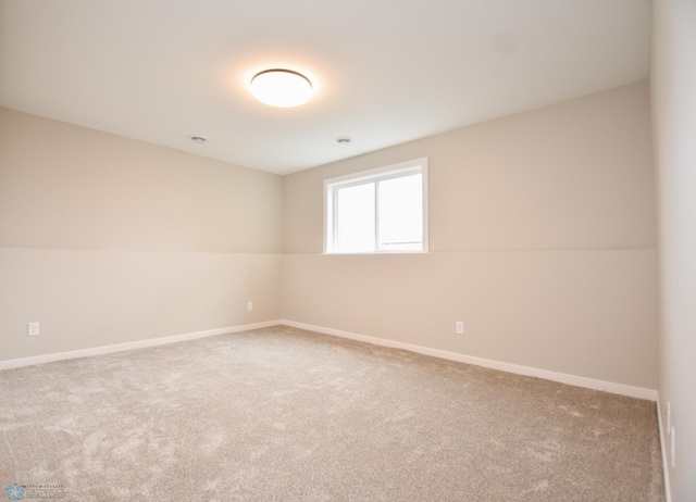 spare room with carpet and baseboards