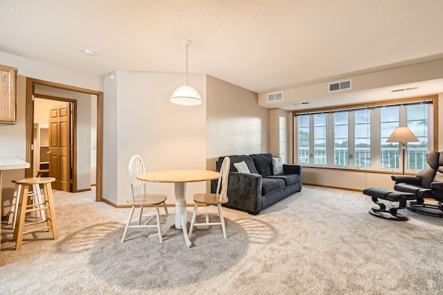 5650 Boone Ave N Unit 315, New Hope, MN 55428 - dining space featuring light carpet and a textured ceiling
