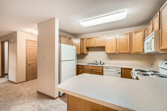 5650 Boone Ave N Unit 315, New Hope, MN 55428 - kitchen featuring white appliances, light countertops, light colored carpet, a peninsula, and a textured ceiling