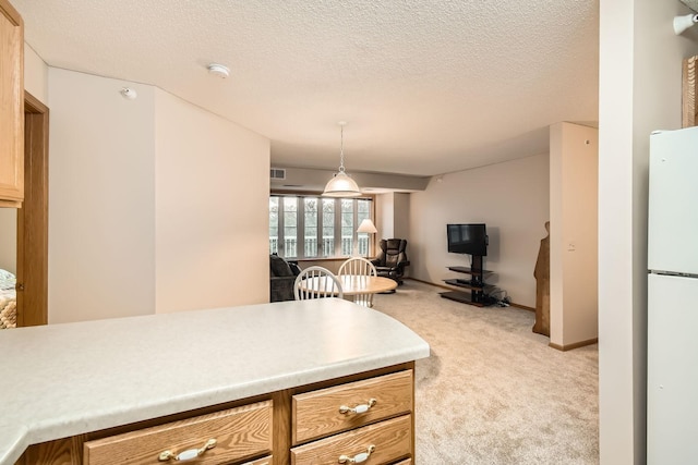 5650 Boone Ave N Unit 315, New Hope, MN 55428 - kitchen featuring freestanding refrigerator, light carpet, light countertops, open floor plan, and a textured ceiling