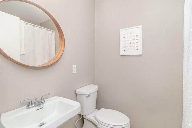 full bathroom with toilet and a sink