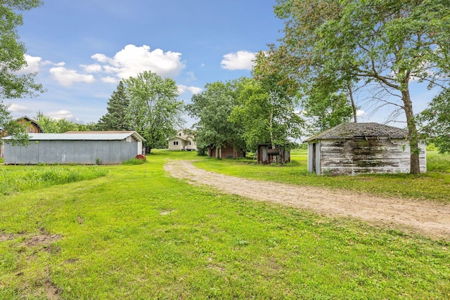 4235 277th Ave NW, Isanti, MN 55040 - view of green lawn featuring an outdoor structure and an outbuilding
