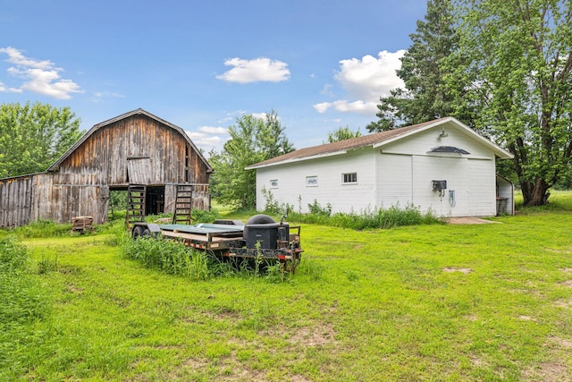 4235 277th Ave NW, Isanti, MN 55040 - view of green lawn with a barn and an outbuilding