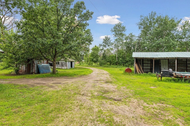 4235 277th Ave NW, Isanti, MN 55040 - view of yard with an outbuilding, a pole building, and dirt driveway