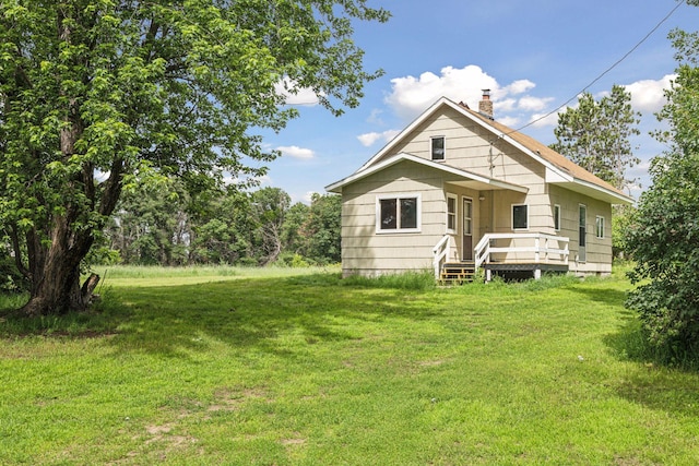4235 277th Ave NW, Isanti, MN 55040 - back of property with a chimney and a yard