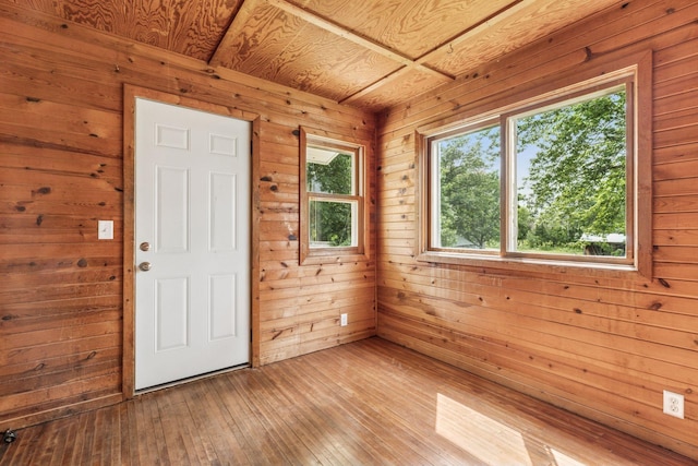4235 277th Ave NW, Isanti, MN 55040 - spare room featuring wood walls, plenty of natural light, hardwood / wood-style floors, and wood ceiling