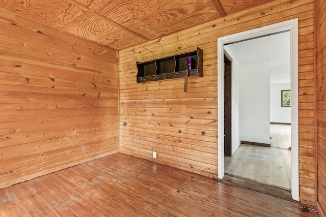 4235 277th Ave NW, Isanti, MN 55040 - unfurnished room with wooden walls and hardwood / wood-style floors