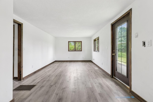 4235 277th Ave NW, Isanti, MN 55040 - unfurnished room with light wood-style floors and baseboards