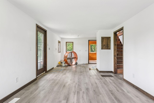 4235 277th Ave NW, Isanti, MN 55040 - spare room featuring light wood-style flooring and stairway