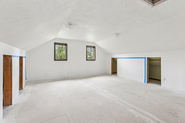 4235 277th Ave NW, Isanti, MN 55040 - additional living space with a textured ceiling and vaulted ceiling