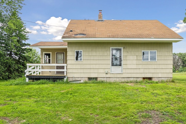 4235 277th Ave NW, Isanti, MN 55040 - rear view of property featuring a lawn, roof with shingles, and a chimney
