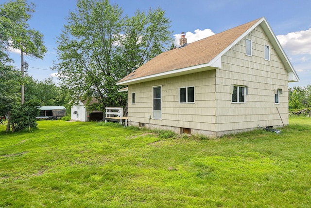 4235 277th Ave NW, Isanti, MN 55040 - back of property featuring a yard, a chimney, and a shingled roof