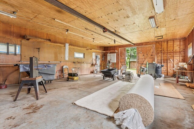 4235 277th Ave NW, Isanti, MN 55040 - misc room featuring unfinished concrete flooring, wood walls, plenty of natural light, and wood ceiling