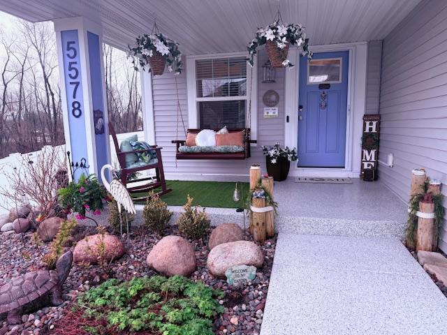 doorway to property with a porch