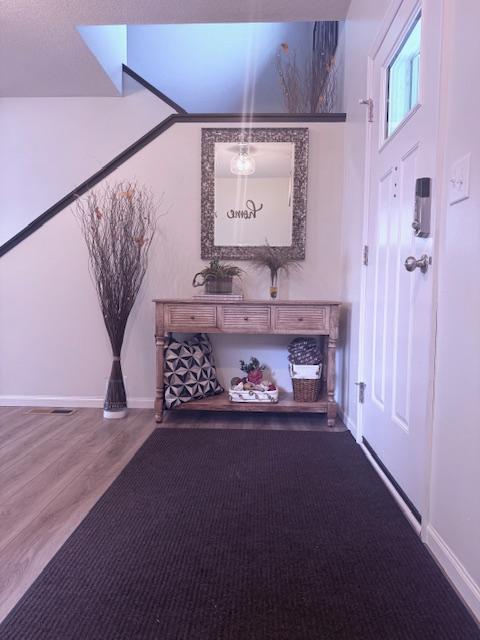 interior space featuring wood finished floors and baseboards