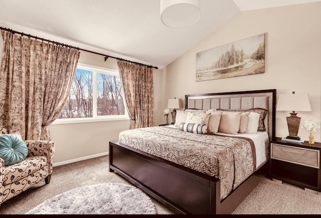 carpeted bedroom with lofted ceiling and baseboards
