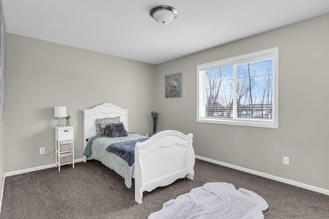 bedroom with baseboards and carpet