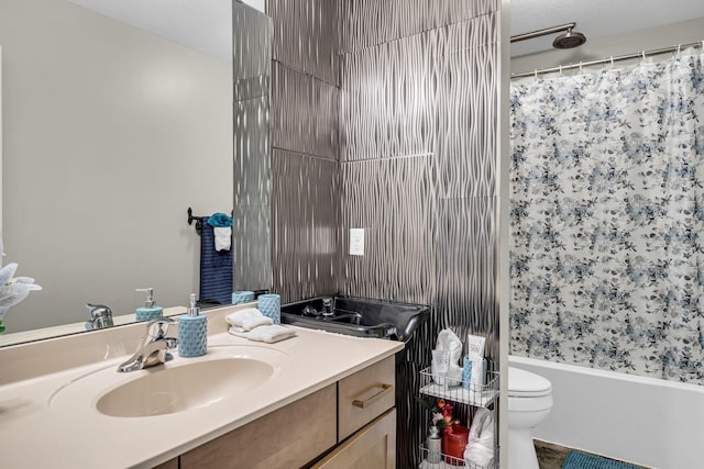 bathroom featuring shower / bath combo, toilet, and vanity