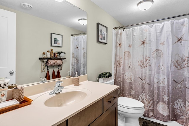bathroom with visible vents, a shower with curtain, vanity, and toilet