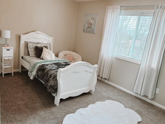 carpeted bedroom with baseboards