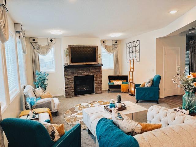 living area with plenty of natural light and a fireplace