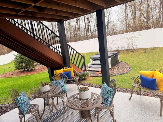 view of patio with stairway and fence