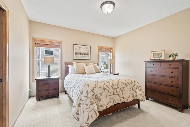 bedroom featuring light carpet