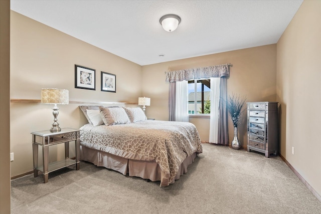 carpeted bedroom featuring baseboards