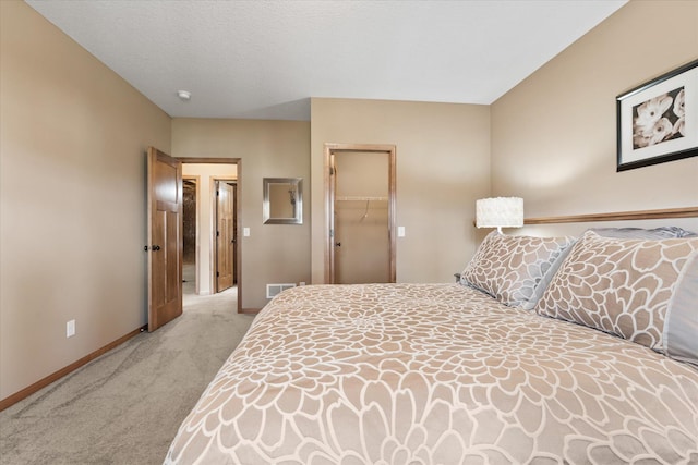 bedroom featuring a closet, visible vents, carpet flooring, and baseboards
