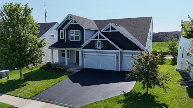 8262 Arrowwood Ln N, Maple Grove, MN 55369 - view of front of house featuring asphalt driveway, a front lawn, a shingled roof, and a garage