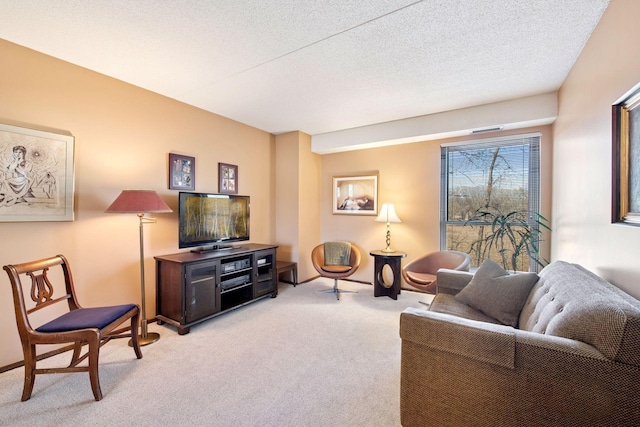 living area featuring light carpet and a textured ceiling