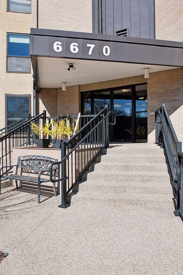 property entrance featuring brick siding