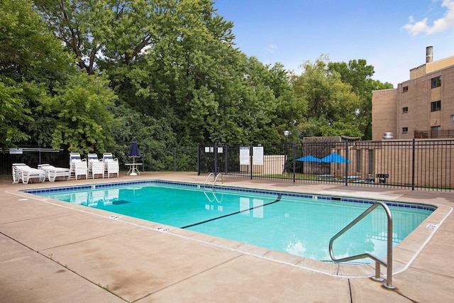 pool featuring a patio area and fence