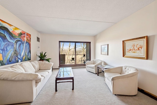 carpeted living area featuring baseboards, visible vents, and a textured ceiling