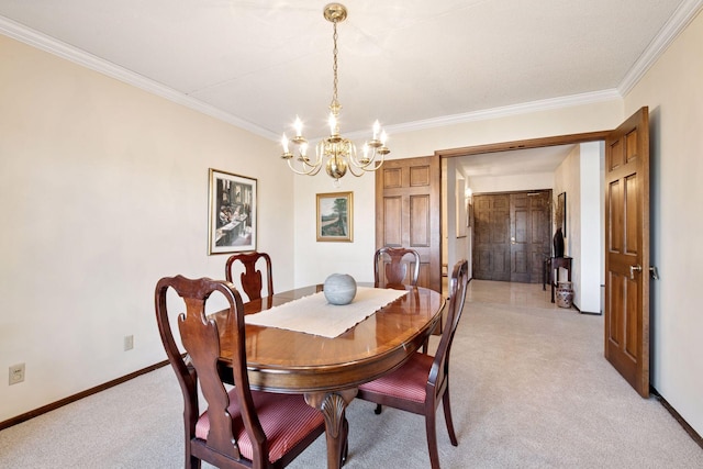 dining room with baseboards, ornamental molding, a chandelier, and light colored carpet