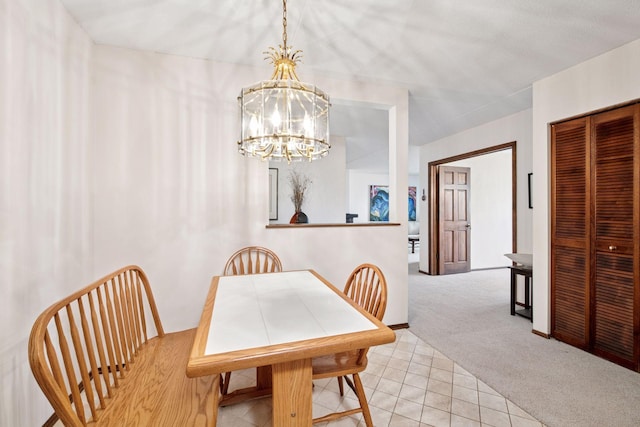 dining space featuring light carpet, a notable chandelier, and light tile patterned flooring