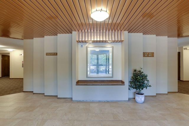 hall with wood ceiling and baseboards