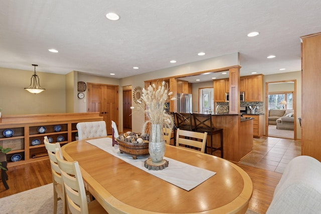 dining space with recessed lighting and light wood finished floors