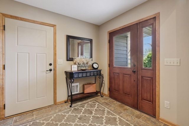 foyer featuring baseboards