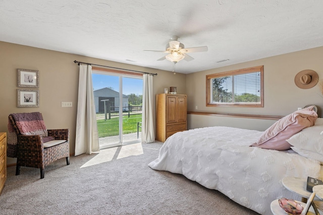 bedroom with access to outside, light colored carpet, and ceiling fan