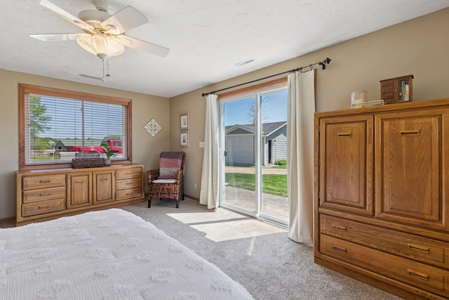 bedroom featuring access to outside, light carpet, multiple windows, and a ceiling fan