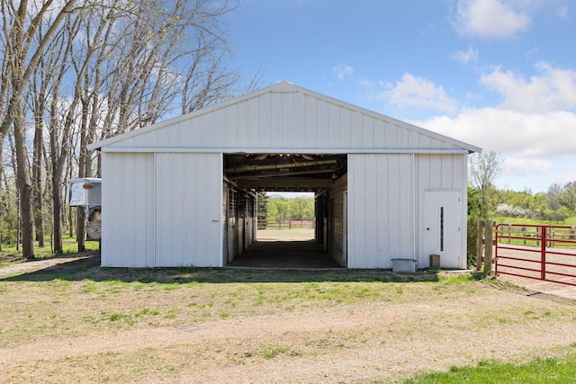 view of outbuilding with an outdoor structure, fence, and an exterior structure
