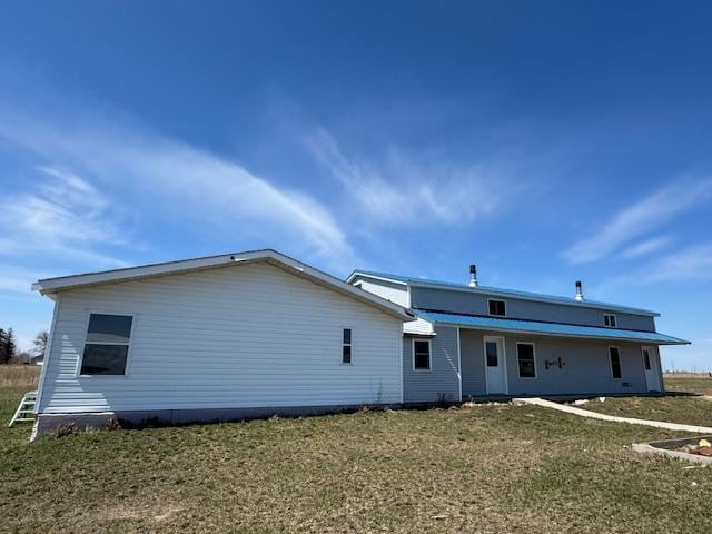 back of property with a yard