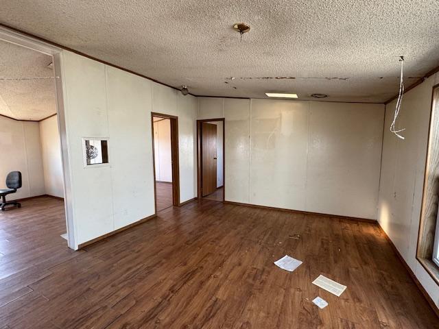 spare room with wood finished floors and a textured ceiling