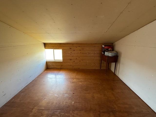 additional living space featuring wood finished floors